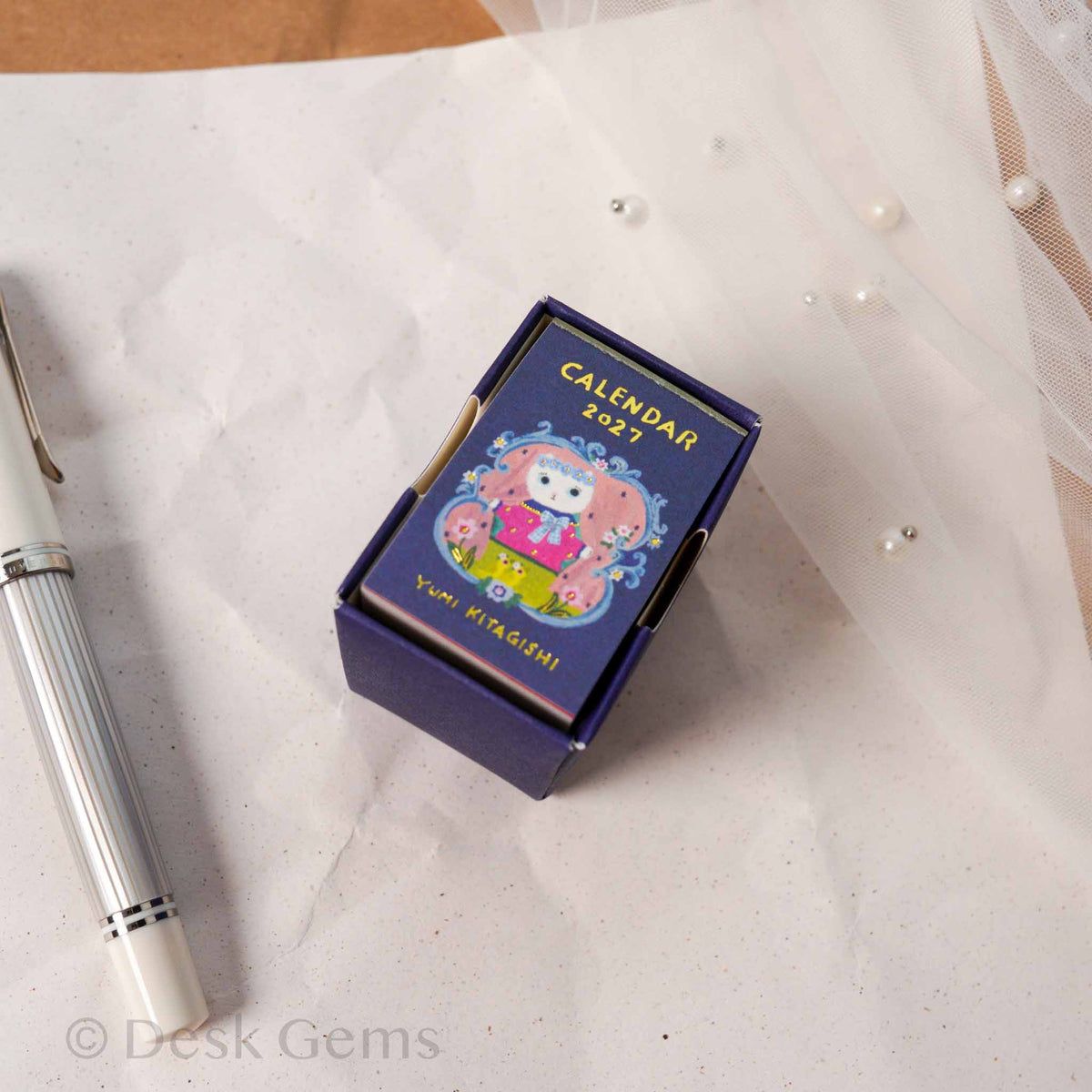 Yumi Kitagishi Mini Mini Daily Calendar 2027 dark navy box with cat in matryoshka illustration