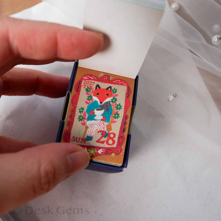 Yumi Kitagishi Mini Mini Daily Calendar 2027 open showing page with fox holding a cup of tea