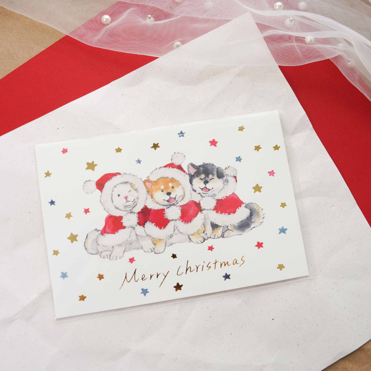 Murata Natsuka Christmas postcard with three Shiba Inu puppies in Santa outfits