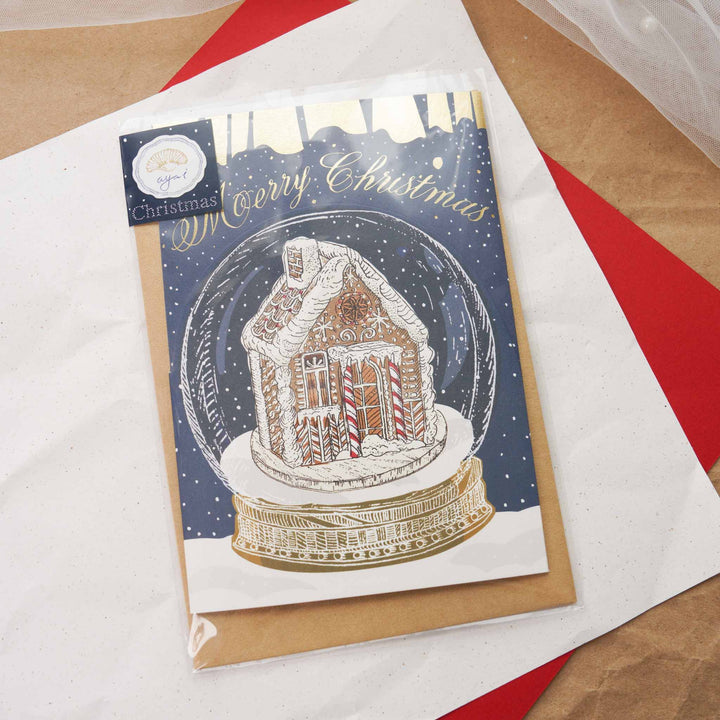 Aya Inoue Christmas trifold card front with snow globe and gingerbread house illustration