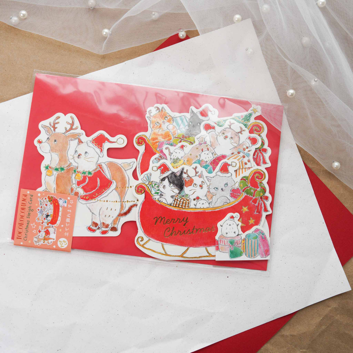 Tocoro Comugi Christmas pop-up card with cats in a sleigh pulled by a cat-reindeer