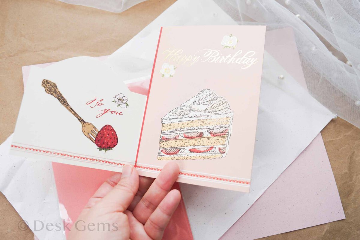 Aya Inoue trifold birthday card partially opened showing strawberry fork panel and short cake cover