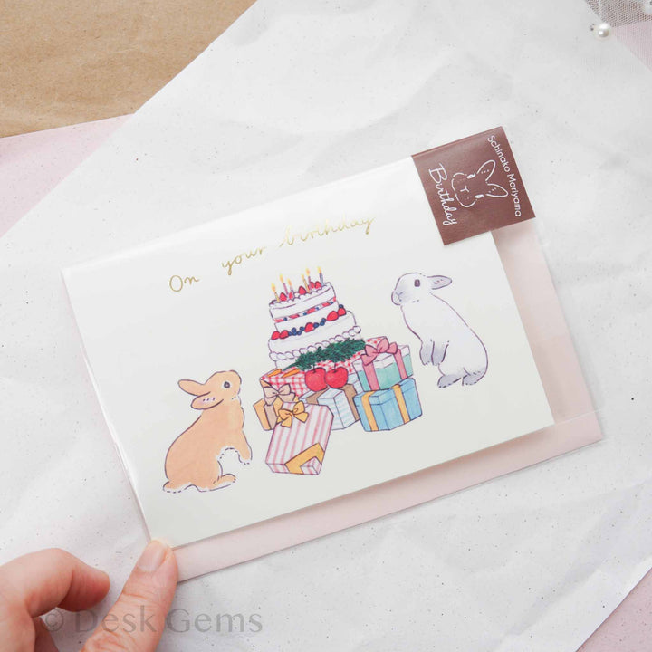Schinako Moriyama pop-up birthday greeting card with two bunnies, a birthday cake, and colorful wrapped presents