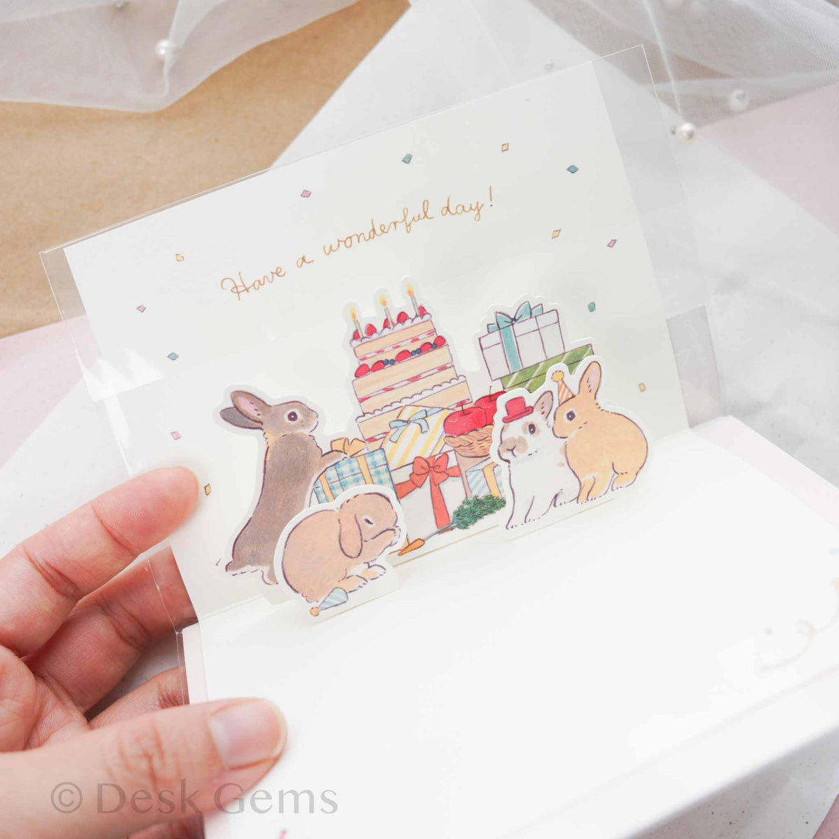 Inside of Schinako Moriyama pop-up birthday card showing pop-up bunnies with cake, presents, and confetti