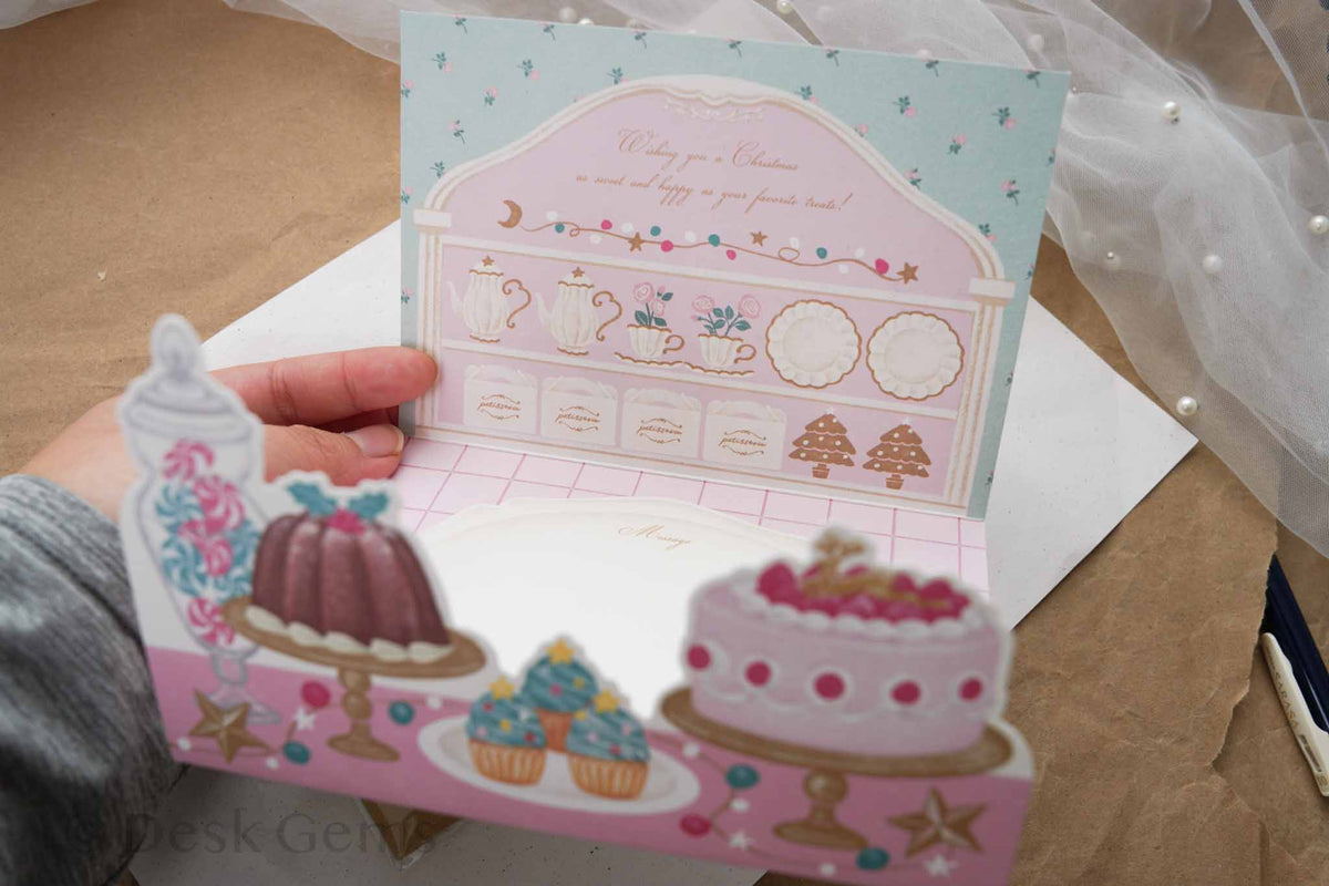 Arakarudo Christmas trifold card opened inside with patisserie cupboard and pop-up cakes