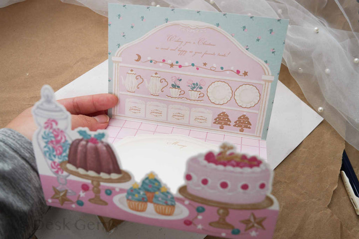 Arakarudo Christmas trifold card opened inside with patisserie cupboard and pop-up cakes